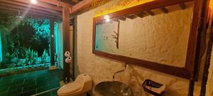 a bathroom with a toilet in a room with a window at Posada Turistica Dantayaco in Mocoa