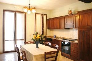 una cocina con una mesa con un jarrón de flores. en Poggio Bella Vista, en Castiglione del Lago