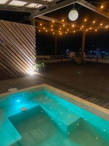 a swimming pool on a patio at night at Loft Praia dos Anjos in Arraial do Cabo