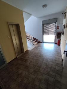 an empty room with a staircase and a hallway at Hotel Il Dollaro in Villa San Giovanni