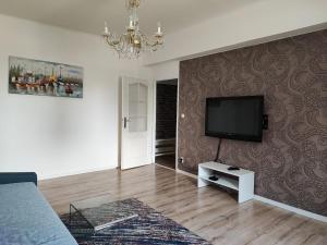 a living room with a couch and a flat screen tv at Apartmán Masarykova třída 61 in Olomouc