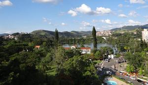 a view of a town with a river and a city at Hotel Brasil in São Lourenço