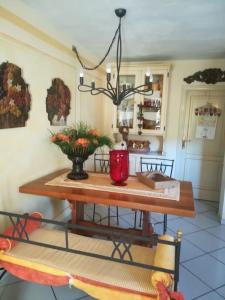a dining room table with a red vase on it at Villa Adriana in Capoliveri +23 photos