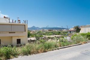 an empty street next to a building on the side of a road at Central Apartment Next To The Beachfront in Heraklio Town