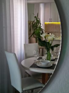 a dining room mirror with a table and chairs at Harmony cozy home in Podgorica
