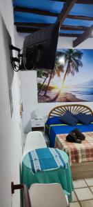 a bedroom with two beds and a tv on the wall at Casa Rural La Fuensanta in Mojácar +62 photos