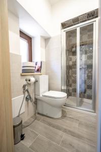 a bathroom with a toilet and a glass shower at Via Venezia 32 House in Petralia Sottana