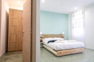 a bedroom with a bed and a sliding door at Via Venezia 32 House in Petralia Sottana