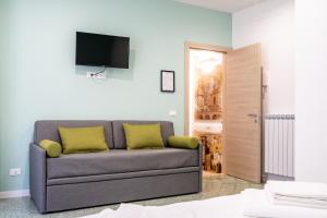 a living room with a couch and a flat screen tv at Via Venezia 32 House in Petralia Sottana