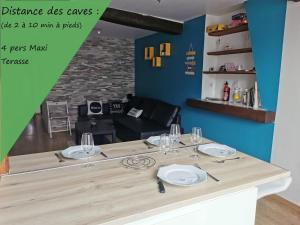 - une table avec des assiettes et des verres à vin dans l'établissement Au Saint Timothée près Caves Champagne, à Reims