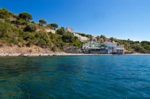 a large body of water with houses on a hill at Pensione Zio Attilio in Casal Velino