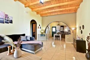 a large living room with a couch and a table at Sia's Holiday Home in Ágios Matthaíos