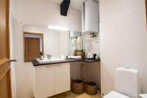 a white bathroom with a sink and a toilet at Stylish two floor Deluxe Apartment - 2 bedroom in Sønderborg +17 photos