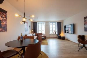 a living room with a table and a couch at Stylish two floor Deluxe Apartment - 2 bedroom in Sønderborg