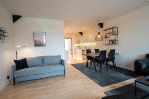 a living room with a couch and a table at Central City Apartment in Sønderborg
