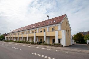 a large building on the side of a street at Central City Apartment in Sønderborg