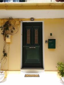 a green door on the side of a building at Hellenes house in Lefkada