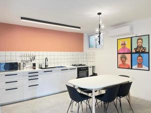 a kitchen with a white table and chairs at Lovely New Central Apartment in Beer Sheva
