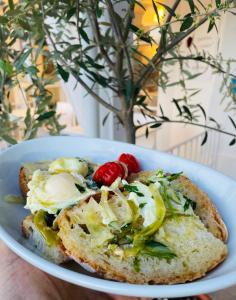 a white plate with a piece of bread with vegetables on it at B&B Villa D'Amato in Peschici