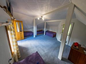 an attic room with two beds and a ceiling at Tolem in Borino