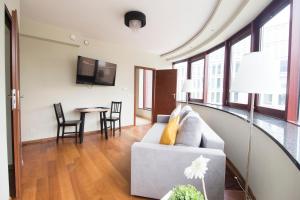 a living room with a couch and a table at Happy Apartments - Just In Center in Wrocław