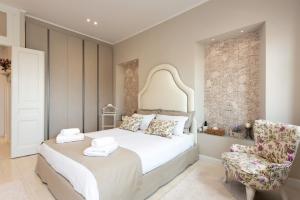 a bedroom with a large bed and a chair at Stemma Veneziano in Corfu Town