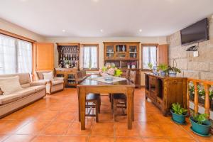 a living room with a table and a couch at Araújo 111 - Traditional House in Leça do Balio