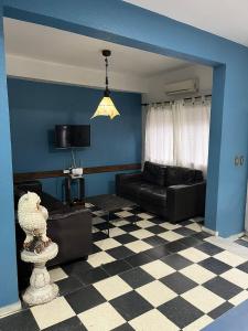 a living room with a couch and a checkered floor at Novohotel Express in Santana do Livramento