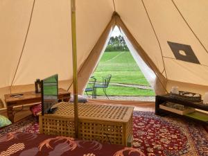a tent with a table and a chair in a room at Roslin Glamping in Roslin