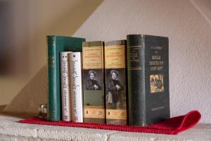 a group of books sitting on a shelf at Kyklamino Castlehouse in Monemvasia