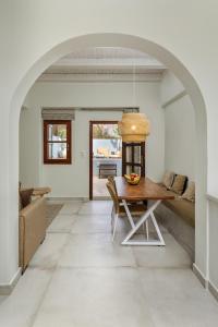 a living room with a table and a couch at Kamares Boutique Residence in Rethymno Town