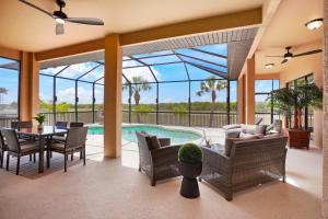 a patio with a table and chairs and a pool at Luxury Villa in Punta Gorda Isles in Punta Gorda