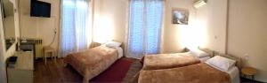Un pat sau paturi într-o cameră la Hotel Διεθνές