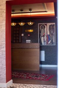 a lobby with a wooden door and some paintings at Boutique Hotel Kooperativa in Pogradec