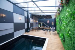 a house with a swimming pool and a dining area at Boutique Hotel Kooperativa in Pogradec