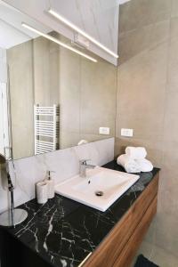 a bathroom with a sink and a mirror at Luxury Apartment Maria Solare in Opatija
