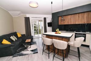 a kitchen and living room with a couch and a table at Luxury Apartment Maria Solare in Opatija