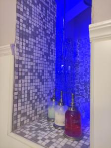 a bathroom with two bottles of soap and a shower at Ca' Moni - Imola in Imola