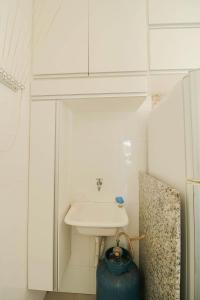 a white bathroom with a sink and a toilet at Incrivel apto c otima localizacao em Uberlandia MG in Uberlândia