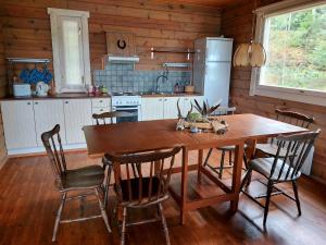 a kitchen with a wooden table and chairs at Uttis Home in Nauvo +36 photos