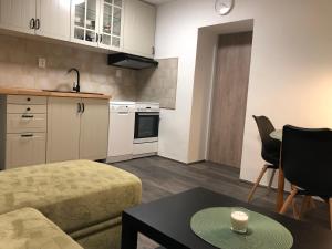 a small kitchen with a couch and a table at SWEET HOME in Krásná Lípa