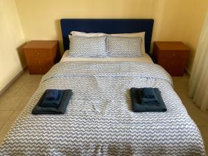 a bedroom with a bed with two towels on it at Beach House Vaccarizzo in Catania