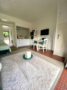 Cottage au sein du "Hameau du golf" de la Bretesche في Missillac: غرفة معيشة مع شمعة على طاولة