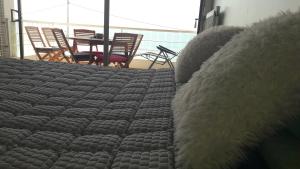a large bed in a room with a table and chairs at Splendide studio front de mer in Menton +35 photos