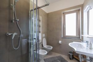 a bathroom with a shower and a toilet and a sink at Villa Alice in Capo Vaticano +29 photos