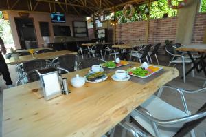 a wooden table with two plates of food on it at Likya Apart Hotel in Kemer