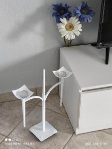 卡利塞亞－豪客迪克斯的住宿－KALLITHEA Nastro Azzurro，一张带两个凳子和花瓶的白色桌子