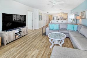 a living room with a couch and a tv at East End Escape in Myrtle Beach