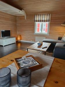 a living room with a couch and a table at Fishermans cabin in Lofoten, Stamsund in Stamsund