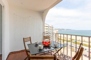 a table with a bowl of fruit on a balcony with the ocean at BLUE HOLIDAYS RELAX & VIEWS Sylvia12 in Empuriabrava